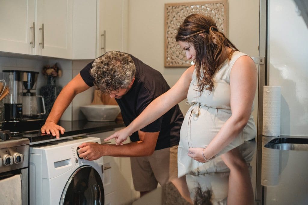 Couple using laundry machine