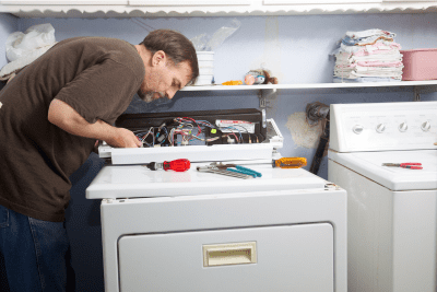 man installing new dryer