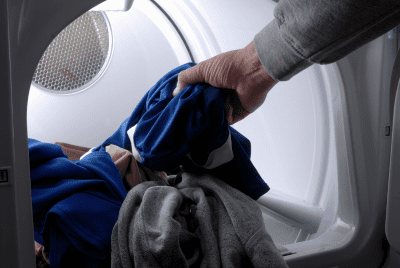 Person taking clothes out of a dryer